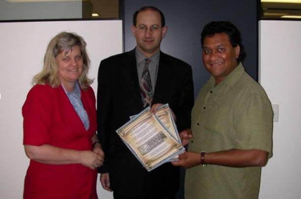 Jeremy Jones (centre) with Barbara and Norman Miller Holding the Certificates The Australian Jewish News 20.12.2002
